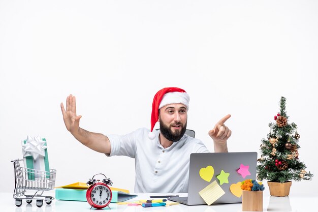 Happy positive young businessman with santa claus hat working