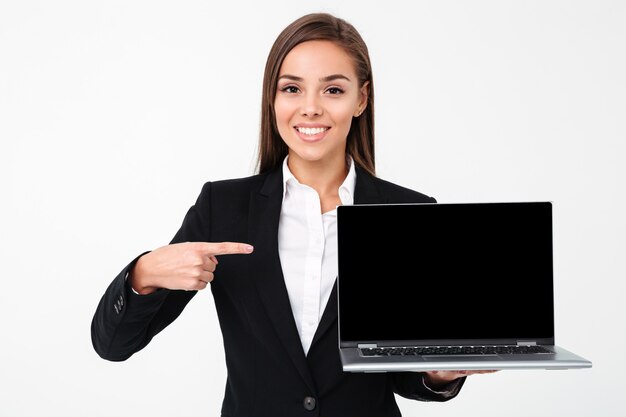 Happy pretty businesswoman showing display of laptop