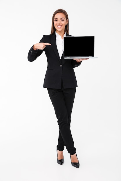 Happy pretty businesswoman showing display of laptop