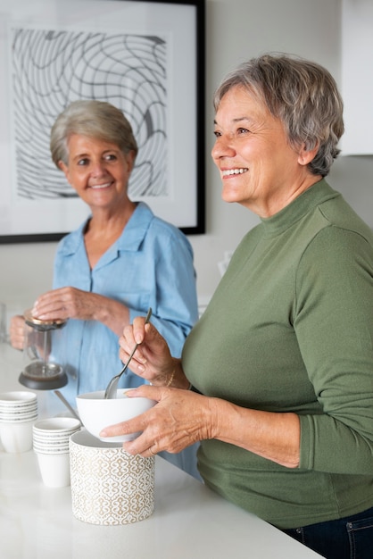 Free photo happy queer eldery women side view