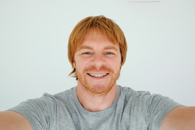 Happy Red-haired Man Taking Selfie Photo