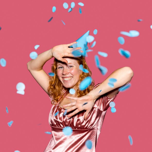 Happy redhead woman throwing confetti