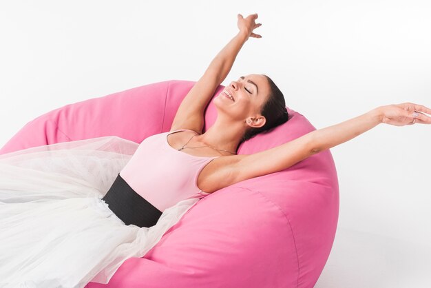 Happy relaxed ballerina lying on the cozy bean bag