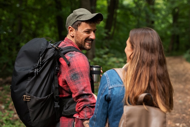 happy and romantic couple traveling together in nature