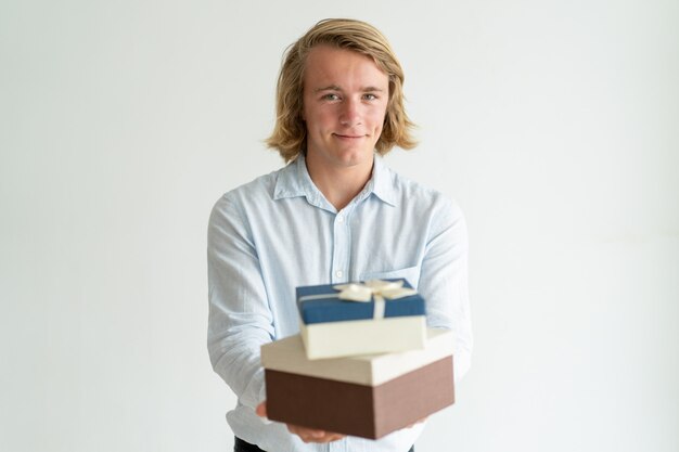 Happy romantic guy presenting gifts