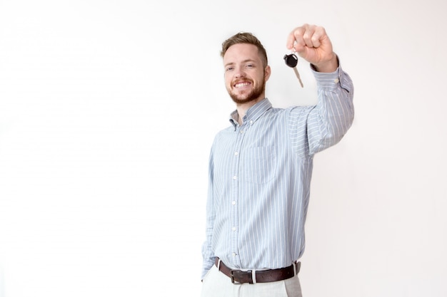 Happy sales manager holding car or house key