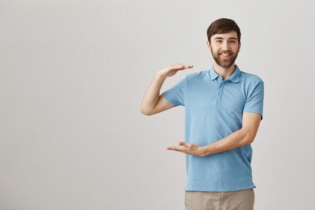 Happy satisfied young bearded man posing