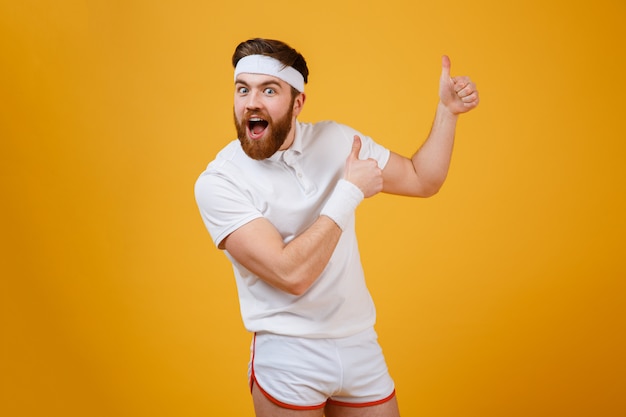 Happy screaming sportsman showing thumbs up