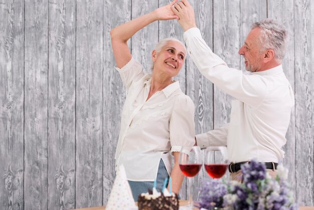 Happy senior couple dancing at birthday party