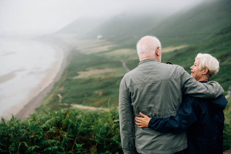 Free Photo happy senior couple enjoying a breathtaking view