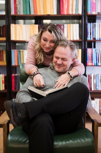 Happy senior couple reading book together