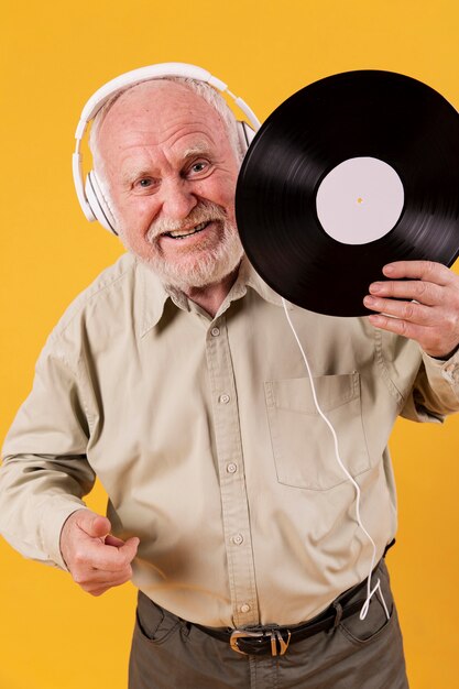 Happy senior holding music record