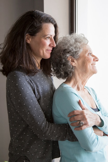 Happy senior lady feeling love of her adult daughter