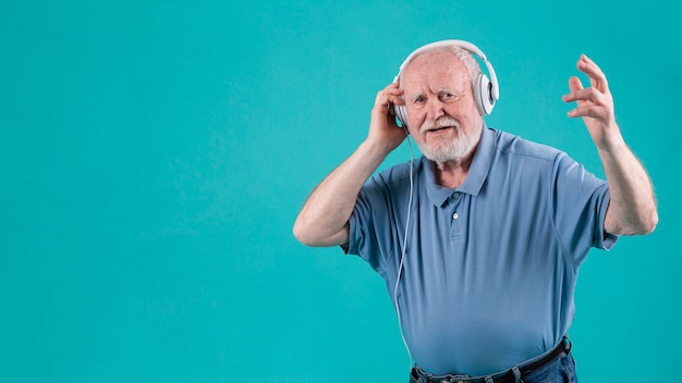 Free photo happy senior listening music