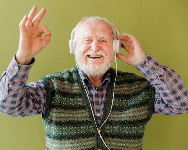 Happy senior listening music