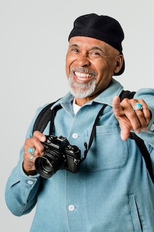 Happy senior man with a digital camera