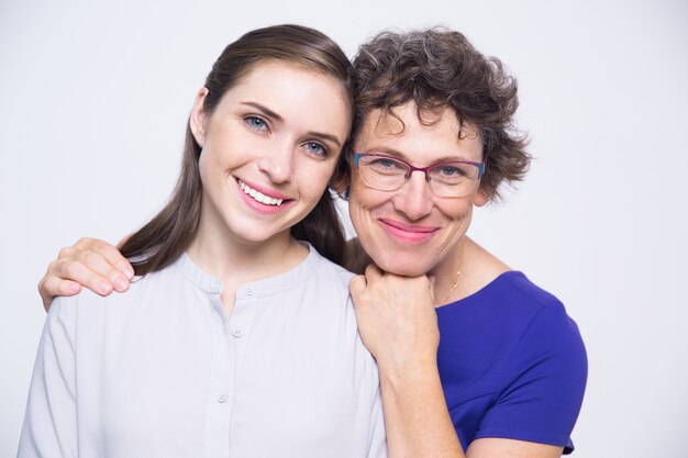 Happy senior mother and young daughter smiling