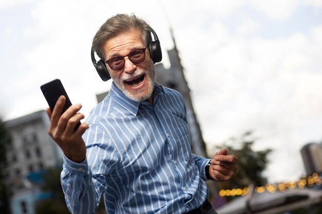 Happy senior person listening to music