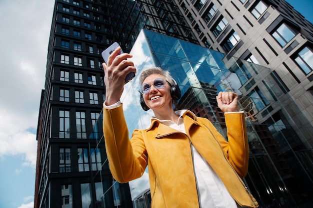 Free photo happy senior person listening to music