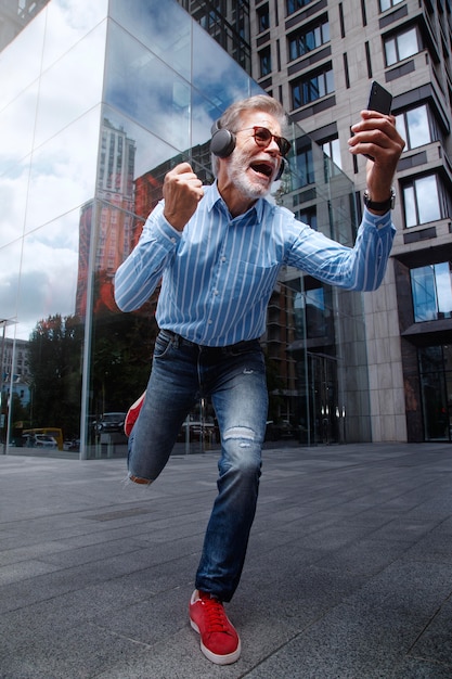 Happy senior person listening to music