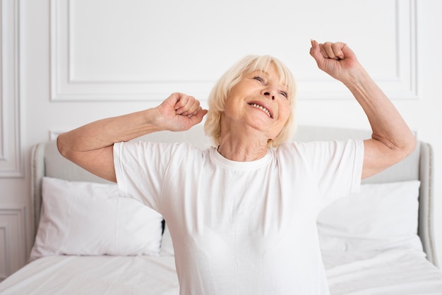 Happy senior sitting in the bedroom