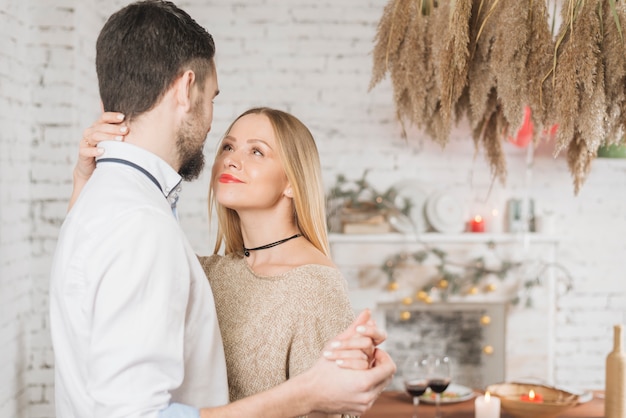 Happy sensual couple dancing indoors