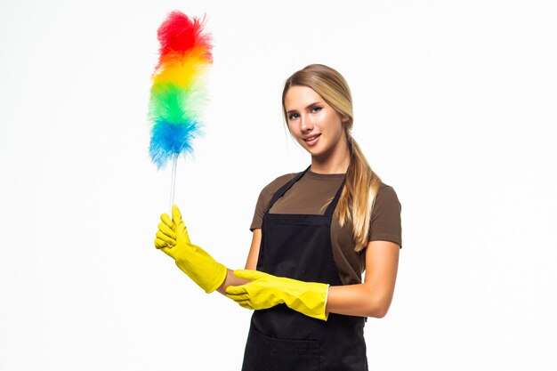 Happy service cleaning woman in pink apron holding blue brush for dust isolated on white