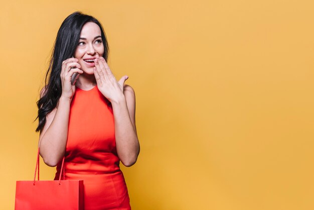 Happy shopping woman having phone call