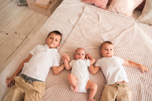 Happy siblings holding hands top view