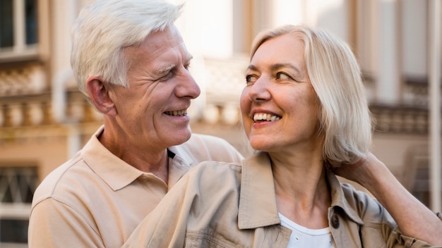 Happy and smiley couple embraced while having a good time outdoors