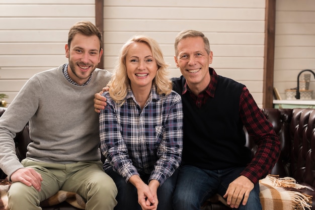 Happy and smiley family posing on sofa