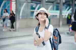 Free photo happy smiling asian student girl with backpack at city background