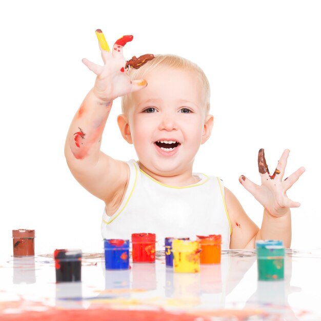 Happy smiling baby with a painted hands isolated on white.