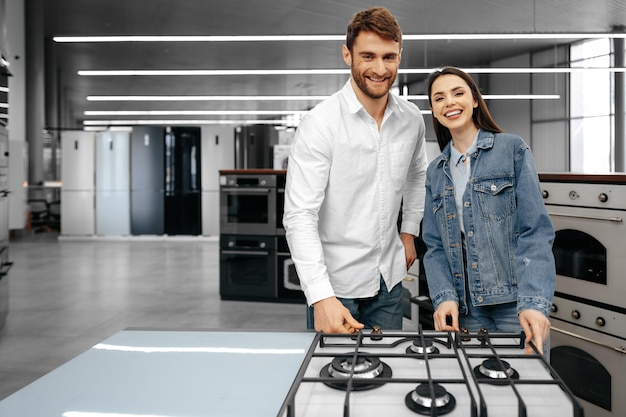 Free photo happy smiling couple just bought new household appliances in hypermarket