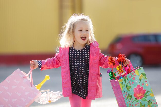 Happy smiling kid shopping child with cart