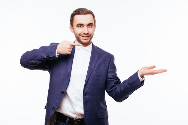 Happy smiling man on shirt presenting and showing something on white wall