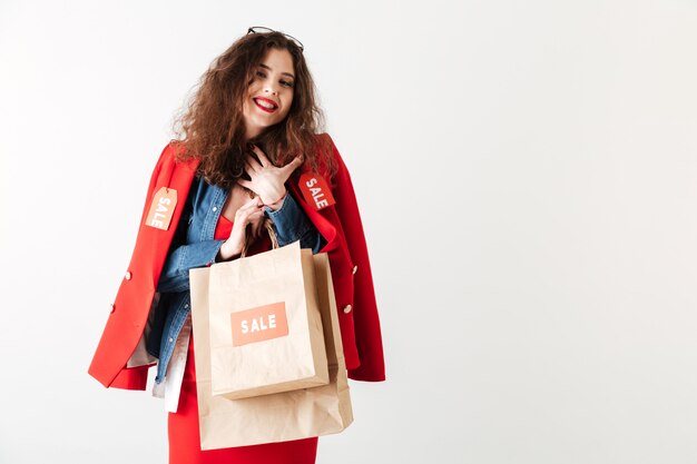 Happy smiling sale woman holding shopping bags