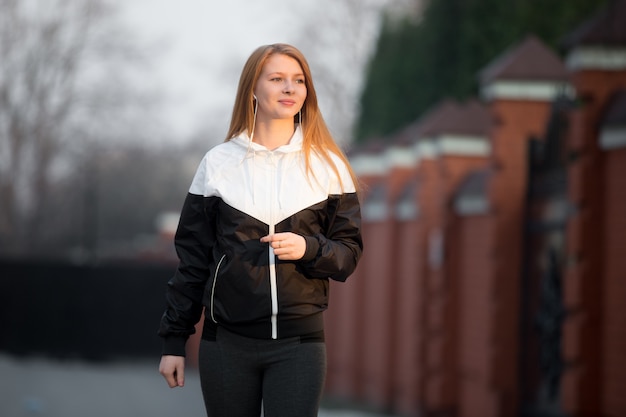 Happy smiling sporty girl walking