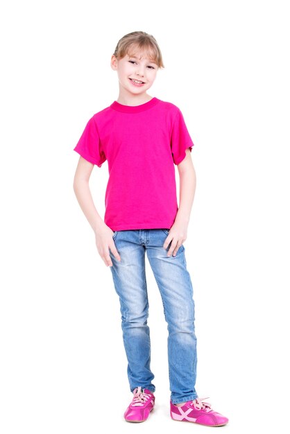 Happy smiling young girl looking at camera in full length standing on white background.