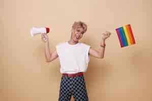 Free photo happy smiling youth asian transgender lgbt waving hold rainbow flag and megaphone announce equality