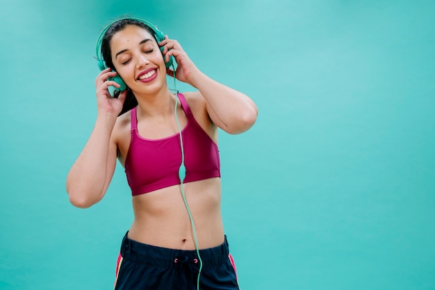 Free photo happy sportswoman listening to music