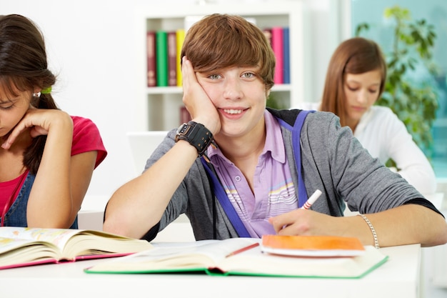 Happy student holding a pen