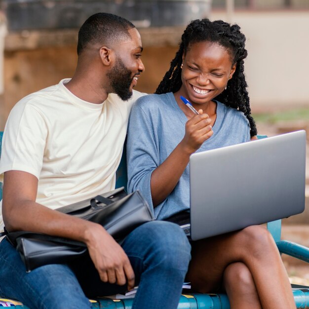 Happy students sitting on bench