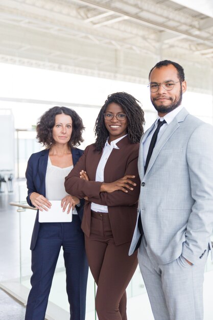 Happy successful business team posing