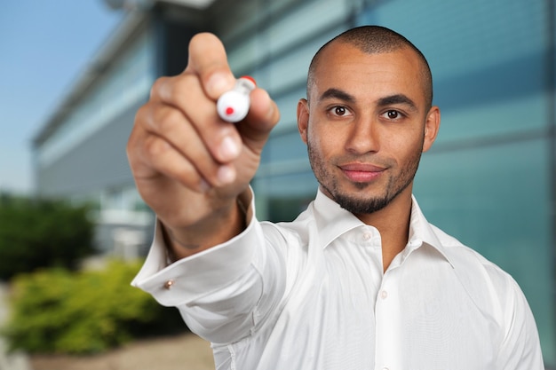 Happy successful businessman pointing on copy space