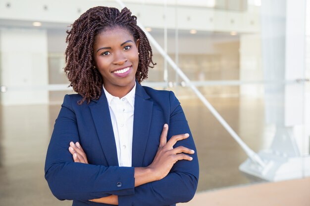 Happy successful professional posing near office building