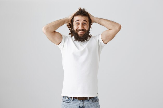 Happy surprised man smiling, looking astonished from great news