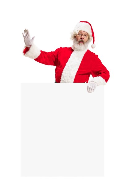 Happy surprised Santa Claus pointing on blank advertisement