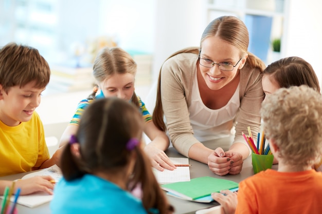 Happy teacher listening to her students