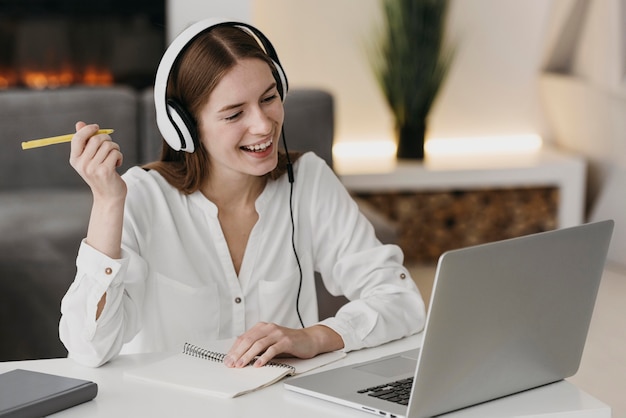 Happy teacher talking with her students online